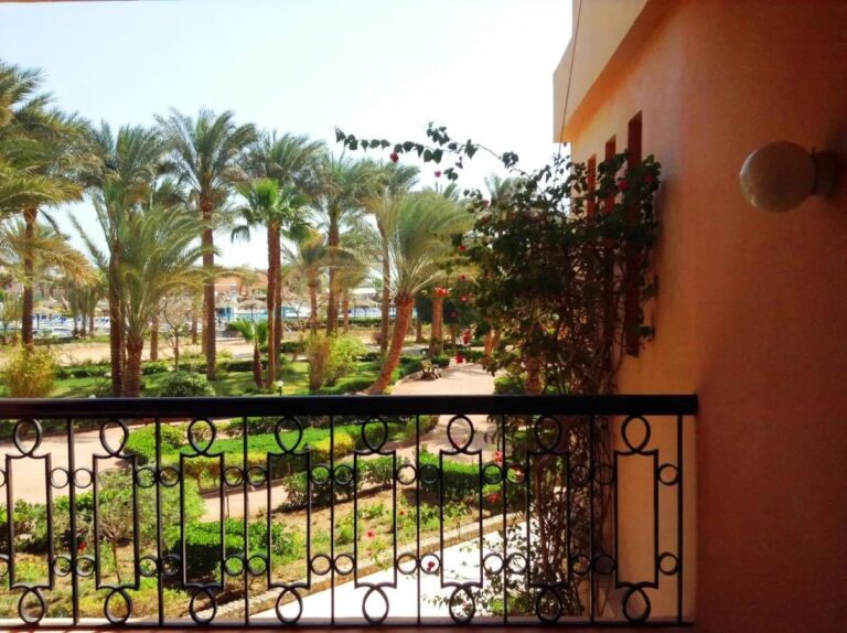 View from a balcony over the palm trees and gardens of Giftun Azur Resort