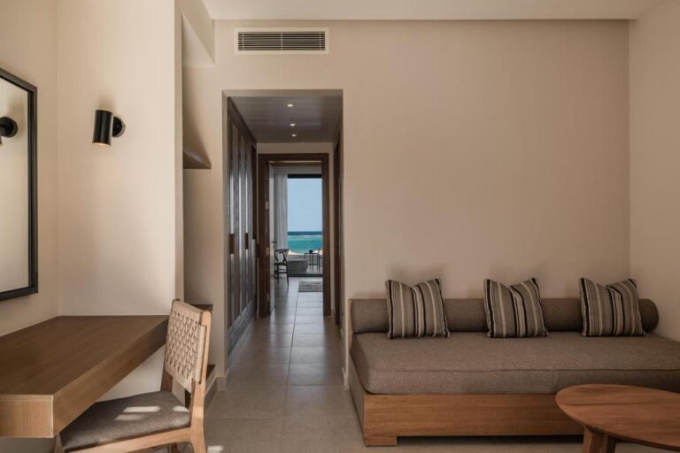 The sitting area of a suite, with the sea at the end of the hallway