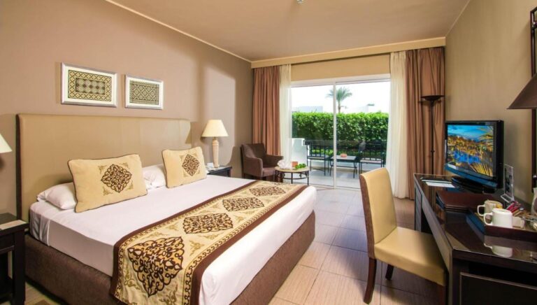 A double room with a desk, opening onto a furnished terrace