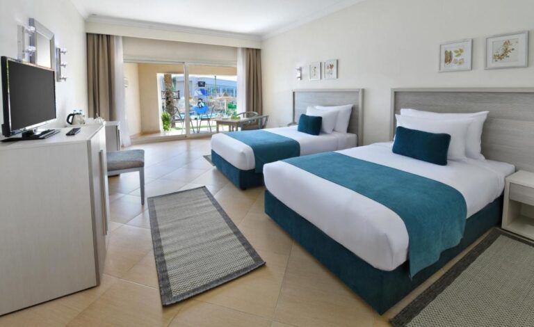 A twin room opening onto a terrace, facing the children's splash area