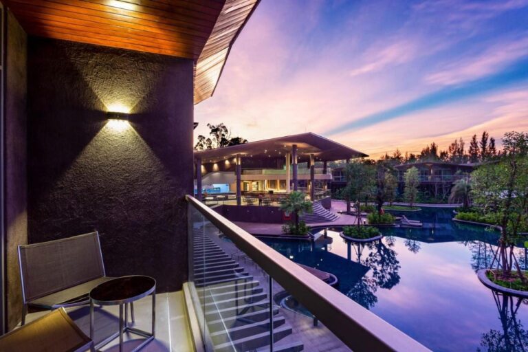 A balcony above the large pool of Kalima Resort Khao Lak, at dusk