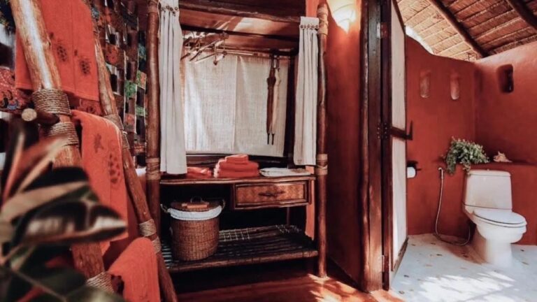 A wardrobe, orange towels and a toilet, with red walls