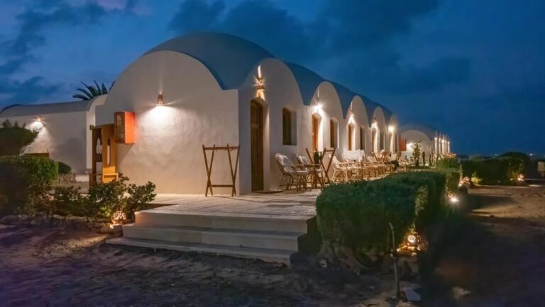 The chalets of Marsa Shagra Village lit up at nightfall, with their terraces