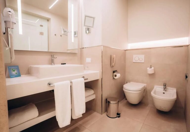 A modern bathroom with a sink, a toilet and a bidet
