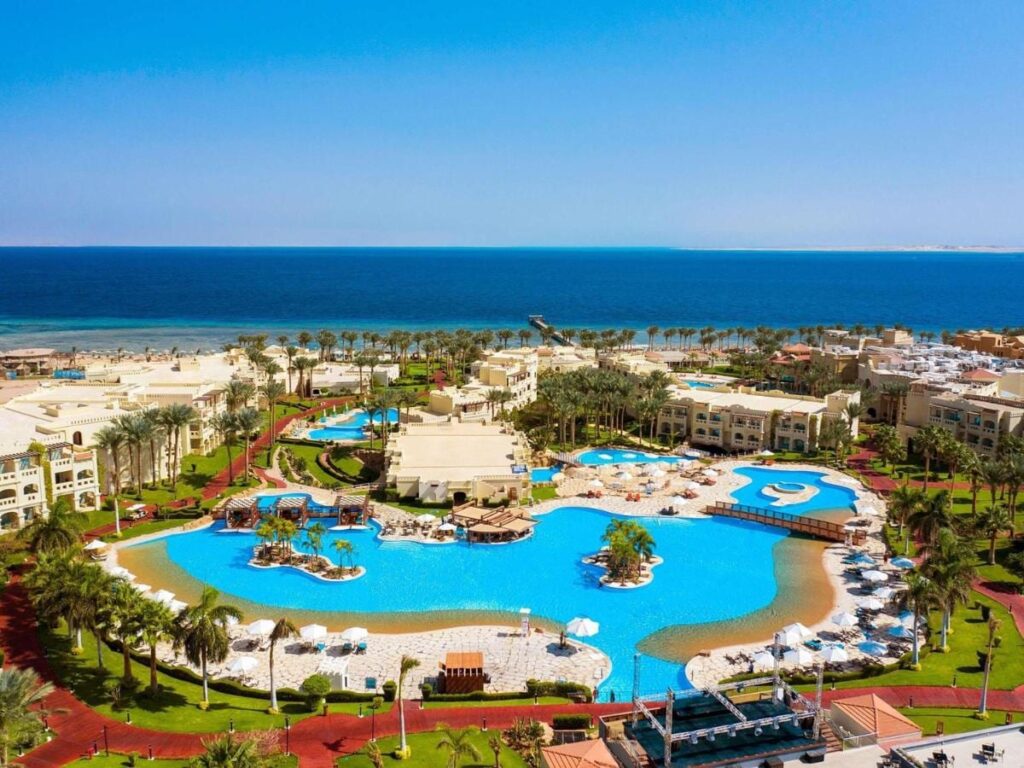 Aerial view of Rixos Sharm El Sheikh, with its lagoon-style pools, palm trees and the Red Sea