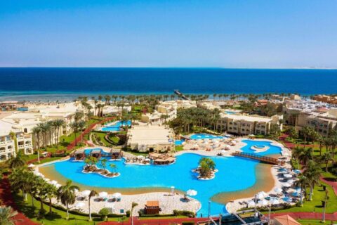 Aerial view of Rixos Sharm El Sheikh, with its lagoon-style pools, palm trees and the Red Sea
