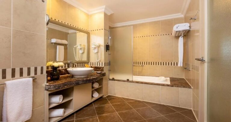 A bathroom with a countertop sink and a bathtub