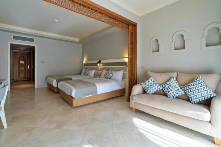 A twin room with a sofa and arched niches in the wall