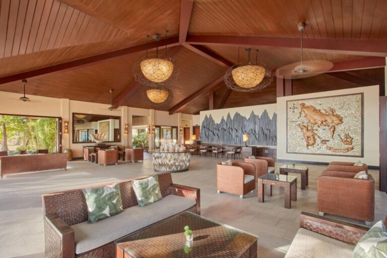 The lobby, with woven sofas, large pendant lights and a big wall map